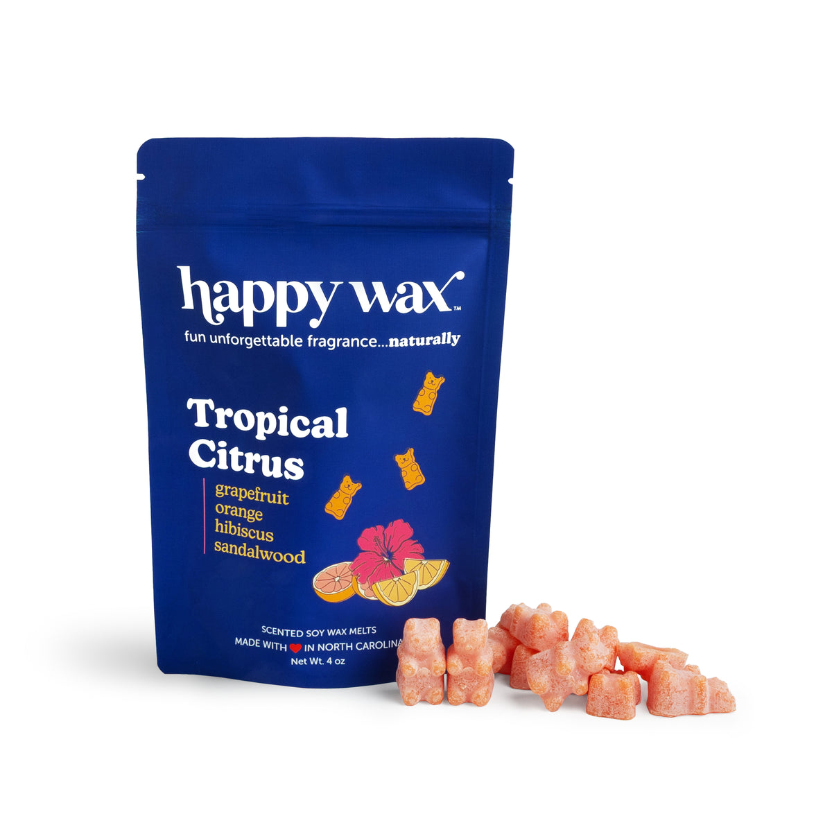 Blue pouch of Happy Wax brand Tropical Citrus scented soy wax melts with scattered peach-colored wax cubes beside it.