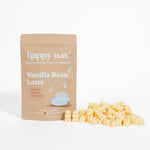 Tan pouch of Happy Wax Vanilla Bean Latte wax melts next to scattered pale yellow wax cubes.