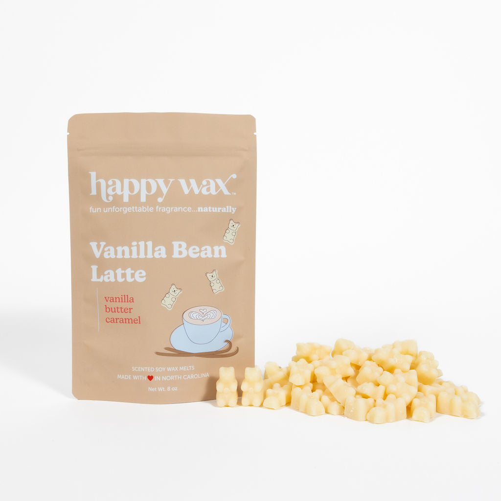 Tan pouch of Happy Wax Vanilla Bean Latte wax melts next to scattered pale yellow wax cubes.