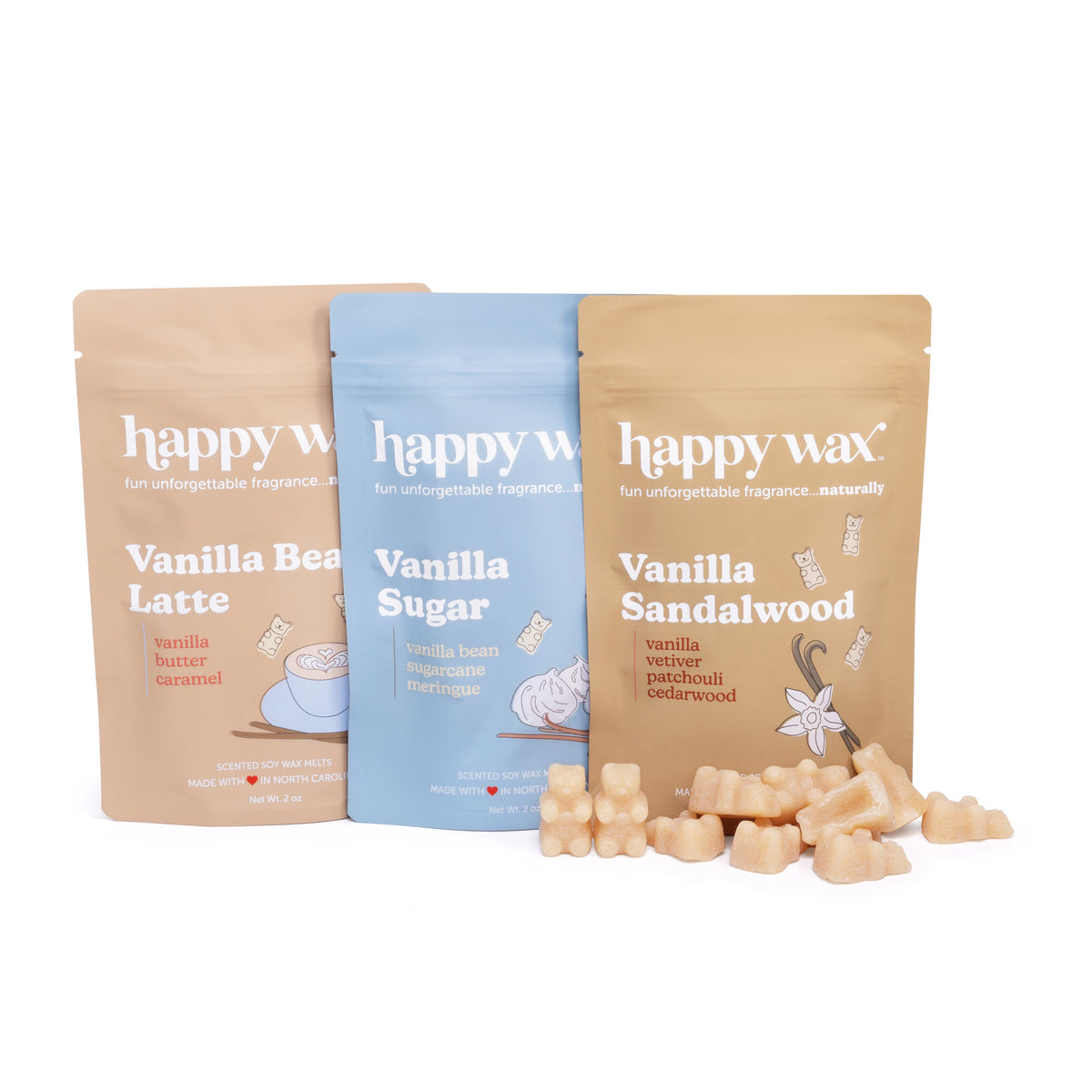 Three Happy Wax pouches in Vanilla Bean Latte, Vanilla Sugar, and Vanilla Sandalwood with wax melts scattered in front.