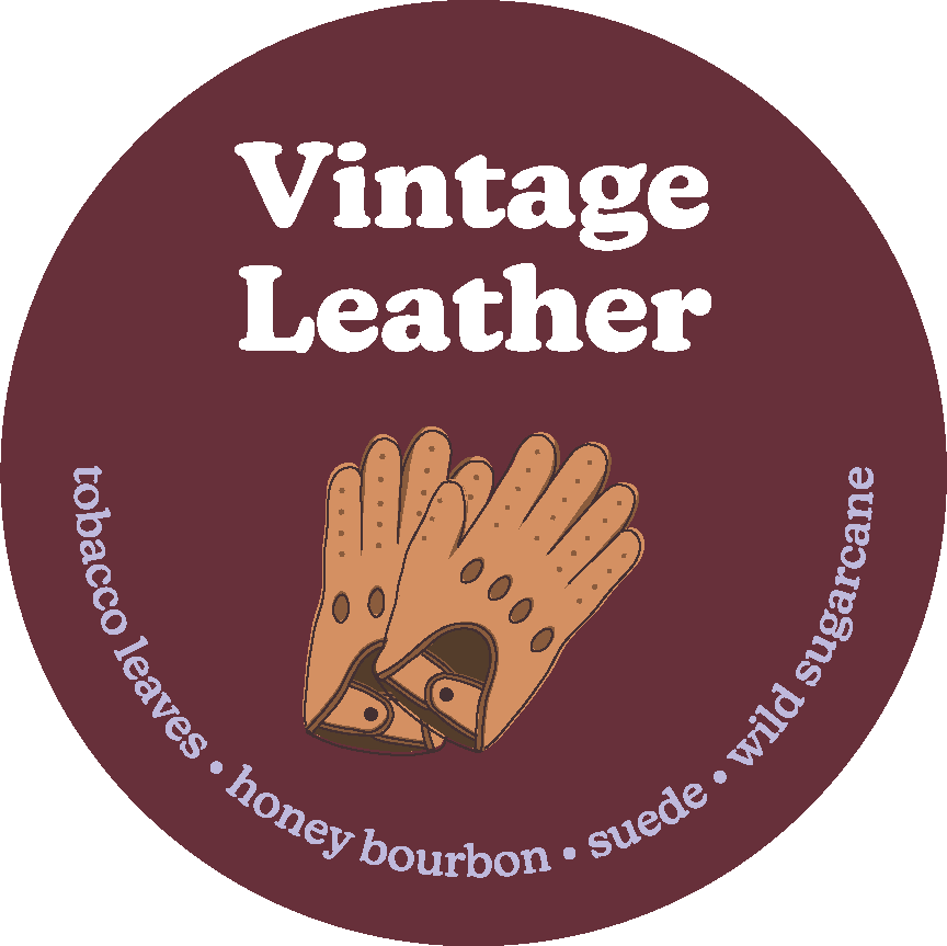 Circular burgundy label with "Vintage Leather" text and illustration of tan leather gloves with scent notes listed around the