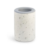 White speckled cylindrical wax warmer with gray rim and circular opening on top.