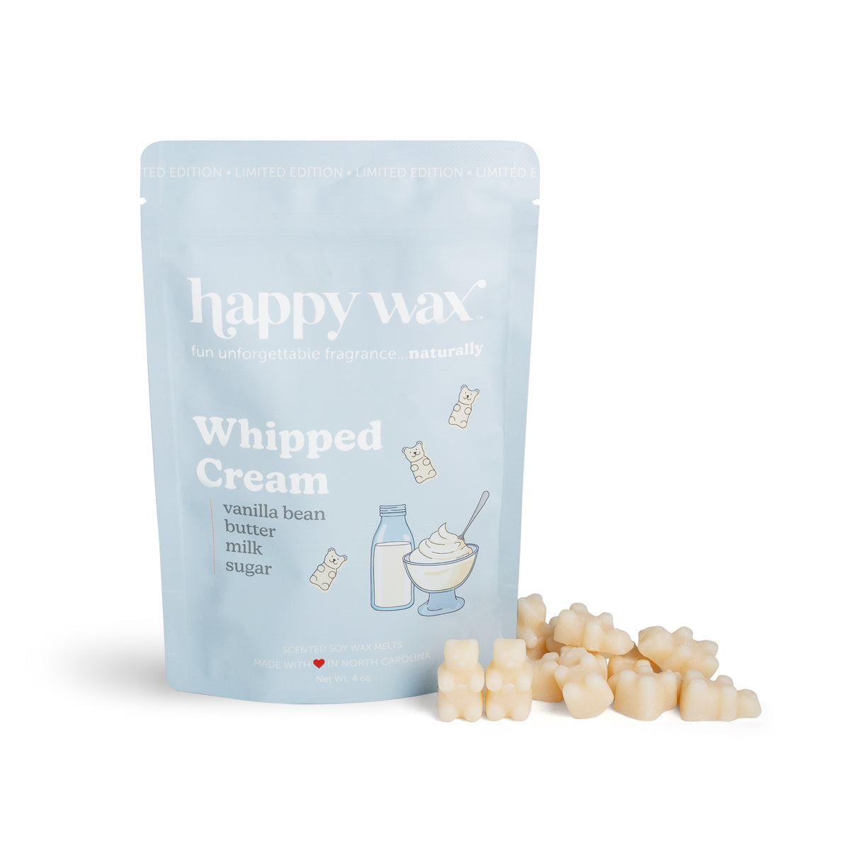 Light blue pouch of Happy Wax whipped cream wax melts with cream-colored wax pieces scattered in front.
