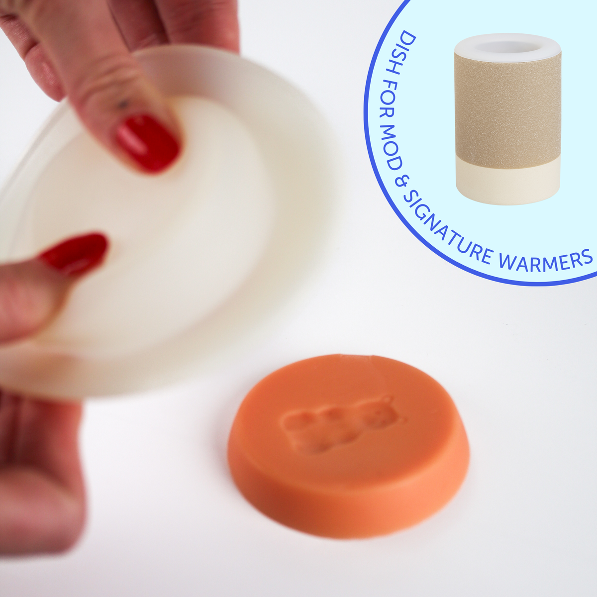 White silicone wax melt dish held in hand with red wax, shown with orange dish and warmer vessel.